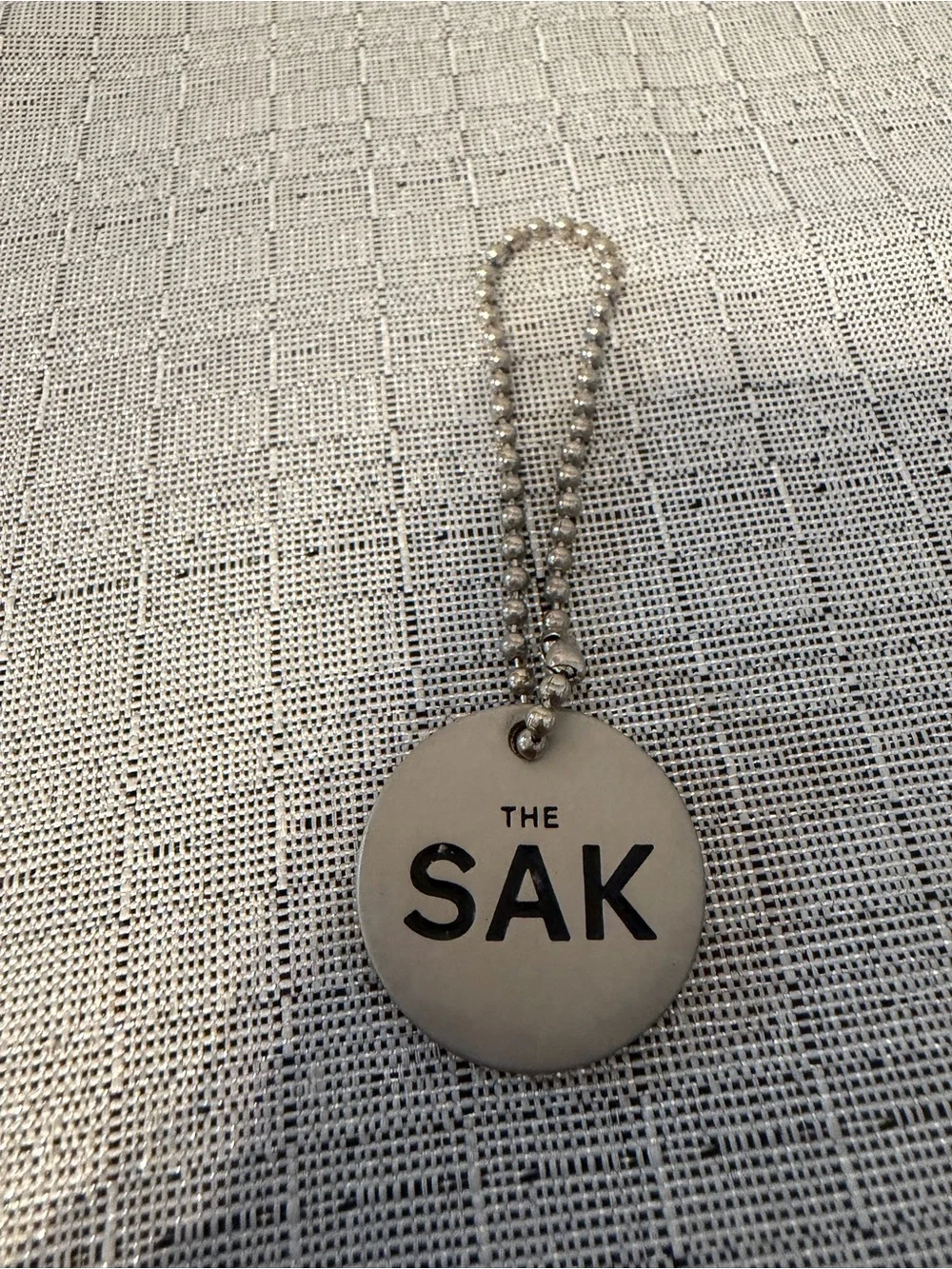 The Sak Silver Logo Charm Keychain
